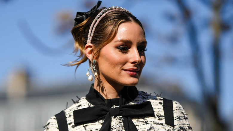 A woman in a black and white jacket with a headband
