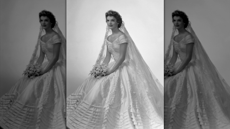 Jacqueline Kennedy seated and wearing a bridal gown with a princess skirt