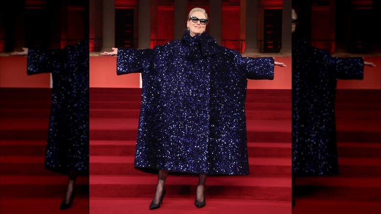 Meryl Streep posing in an oversized, navy, sequin coat at the "A Night with Runway" Gala Reception