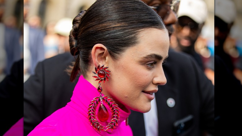 Wearing big earrings 