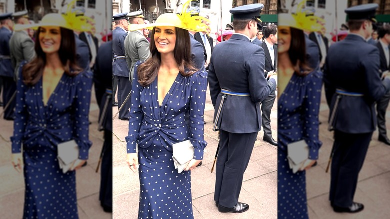 Kaitlan Collins in a polkadot dress and a yellow hat in England