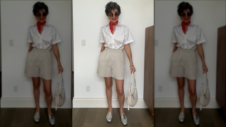 A woman wearing neutral linen shorts with a white shirt