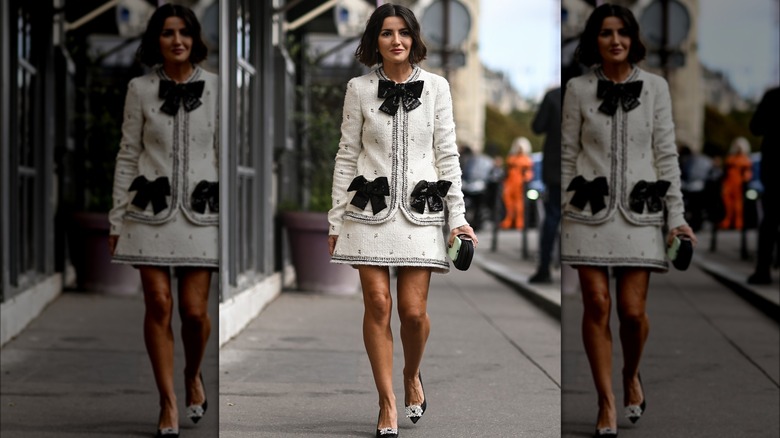 A woman in a boucle jacket and skit 