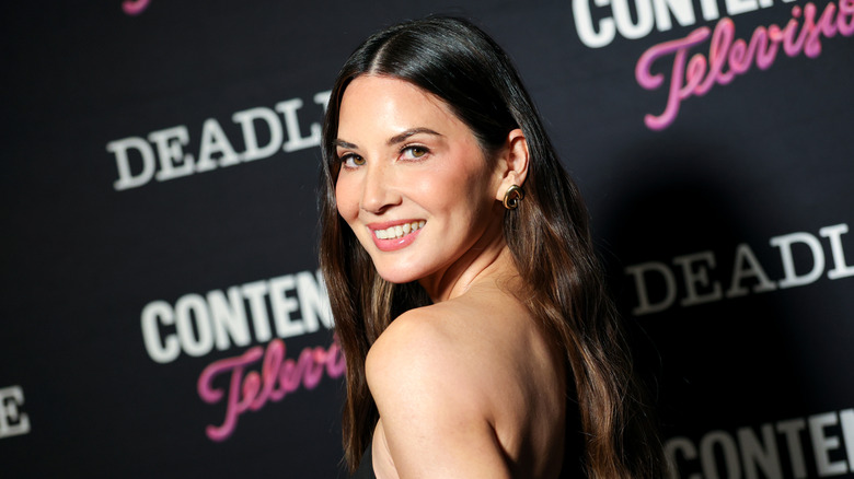 Olivia Munn smiling on the red carpet