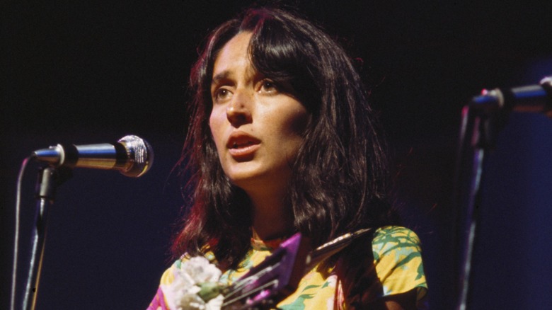 Joan Baez performing on stage with a guitar in 1967