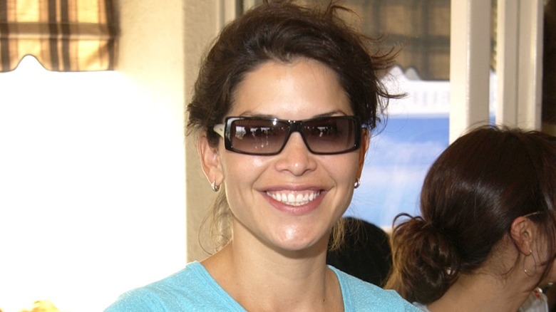 Lauren Sanchez in 2002, smiling and wearing dark sunglasses