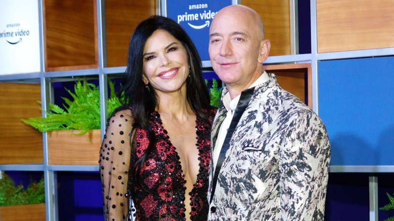 Lauren Sánchez Bezos posing in a low-cut gown next to Jeff Bezos on the red carpet in 2020
