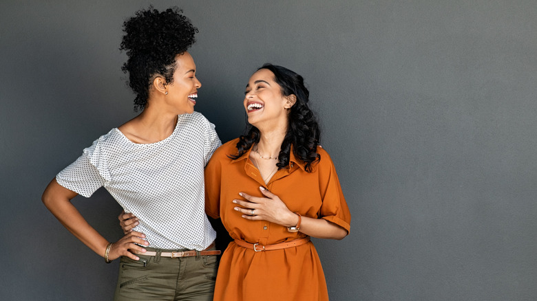 two women embracing and laughing