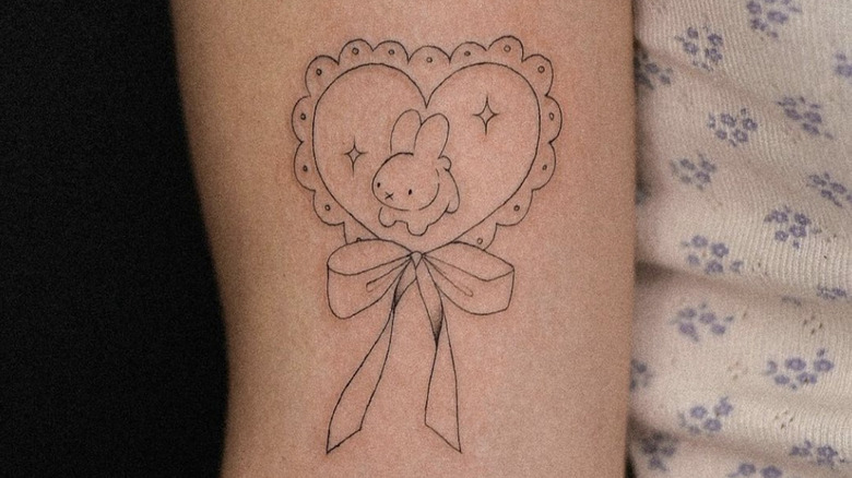 bunny and bow arm tattoo