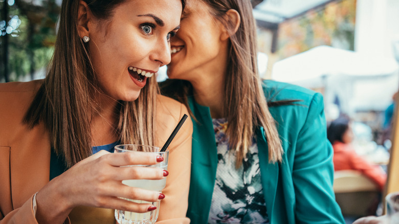 women gossip at cafe