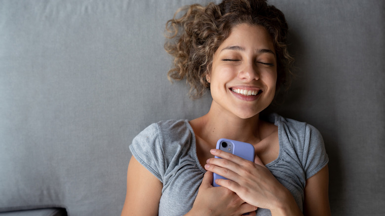 woman holding her phone