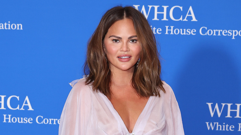 Chrissy Teigen smiling on red carpet