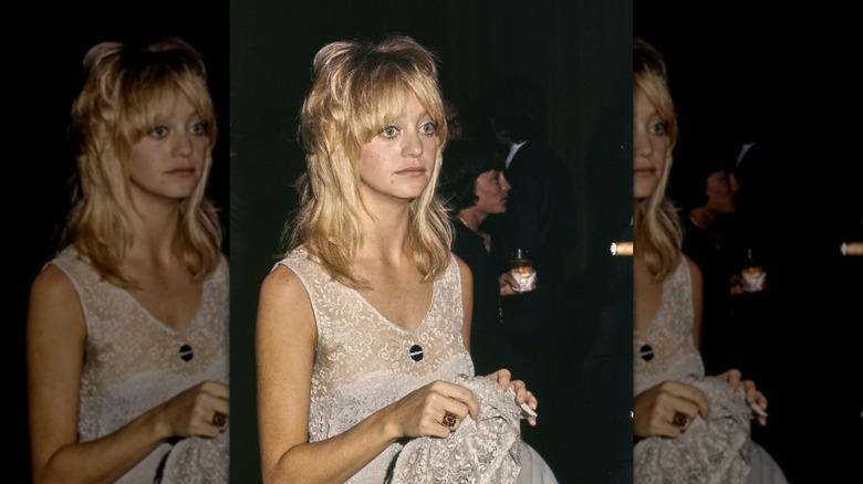 Goldie Hawn wearing a lace white dress with layers in her hair