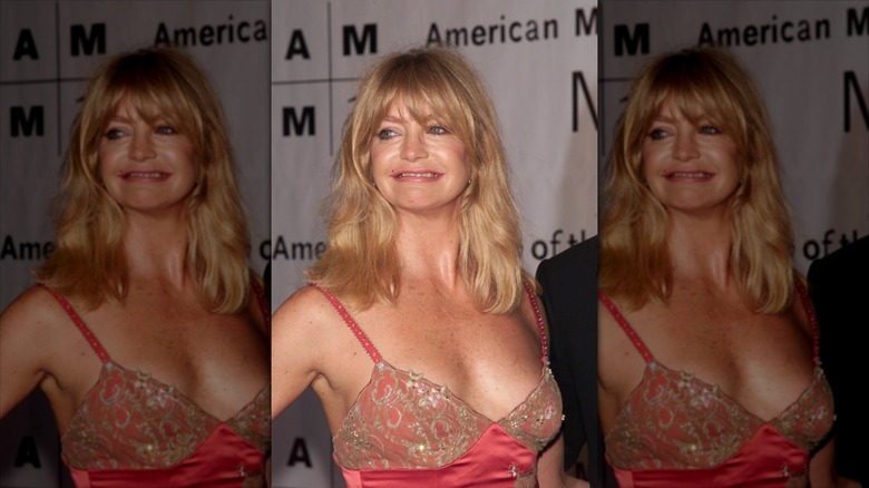 Goldie Hawn smiles wearing an encrusted pink dress