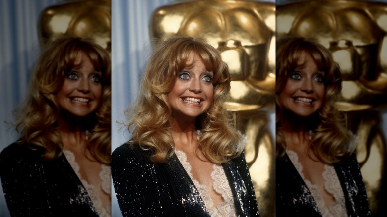 Goldie Hawn smiles wearing a black sequin blazer
