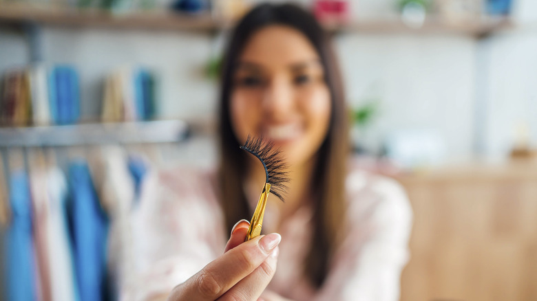 Holding fake eyelashes