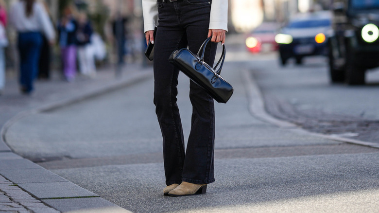 Woman wearing white jacket and black jeans