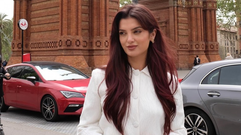 A woman with dark cherry color hair