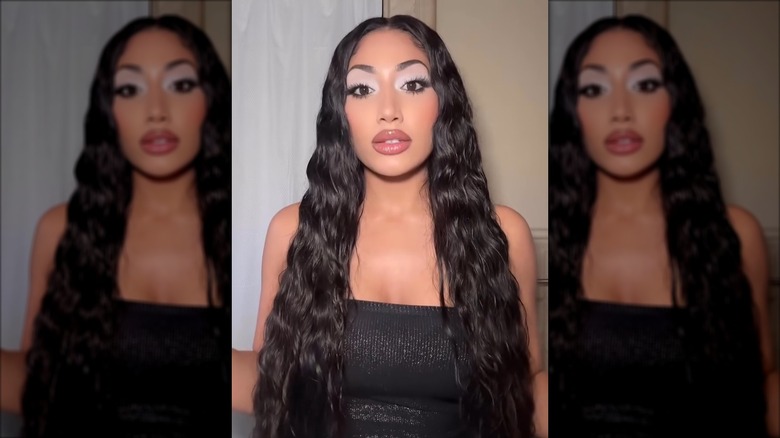 A woman with long, textured hair doing the wet hair look