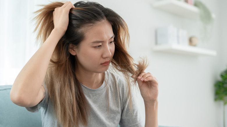 Woman looking at her hair