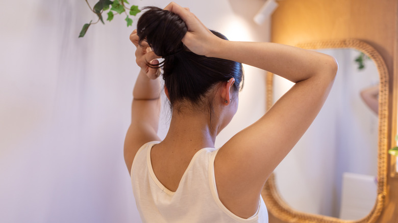 Woman putting her hair up