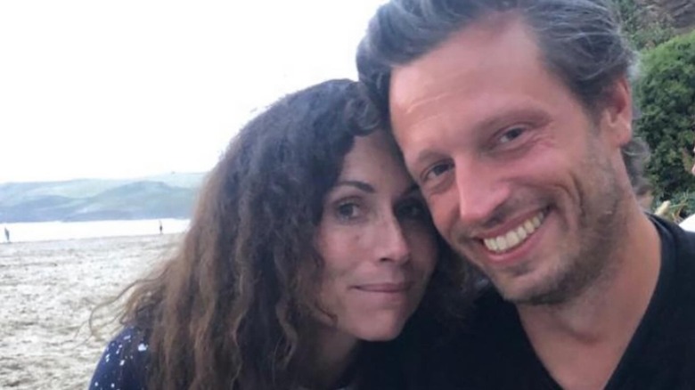 Minnie Driver smiling with Addison O'Dea on a beach around 2018