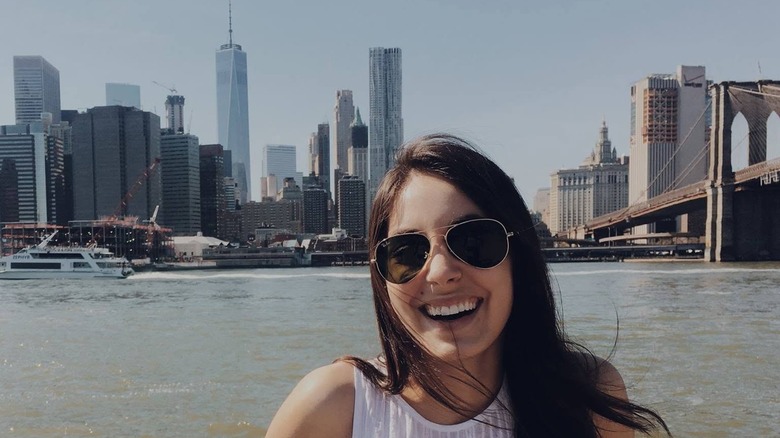 Kristen Vaganos smiling with the New York skyline behind her in 2016