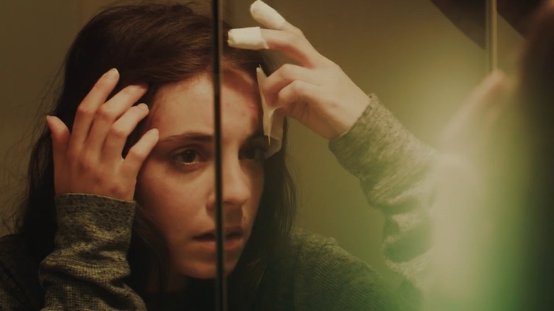 Kristen Vaganos looking in a mirror while in character for the movie I Am Lisa