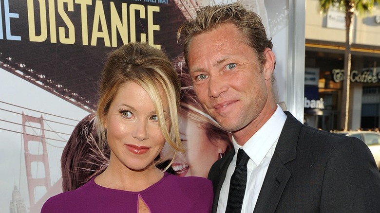 Christina Applegate posing alongside Martyn Lenoble on the red carpet in 2010