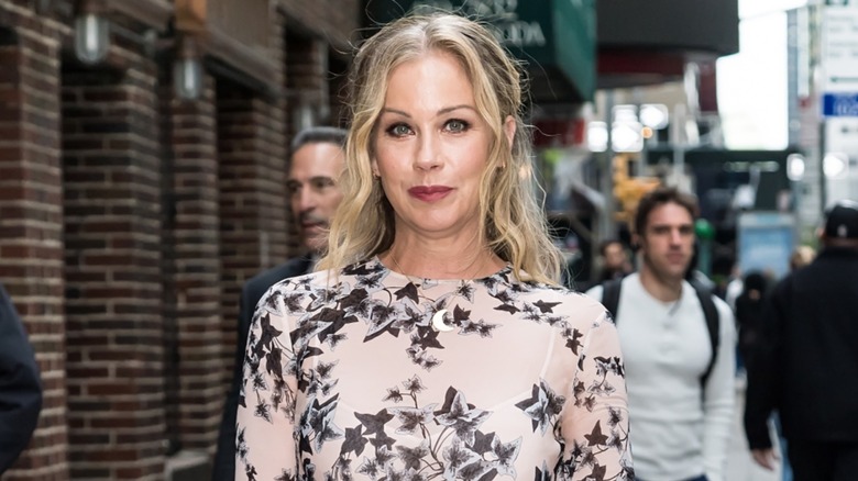 Christina Applegate walking outside in 2017 wearing a sheer, black-and-white dress