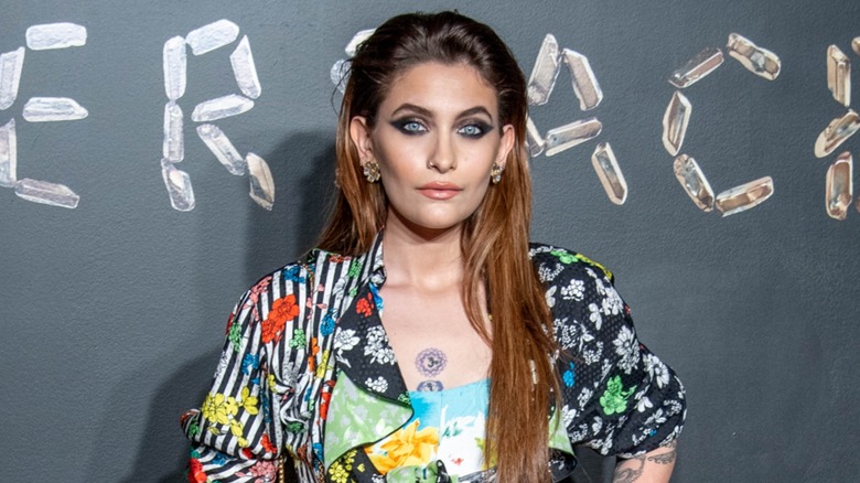 Paris Jackson posing on the red carpet with long, pushed back hair in 2019
