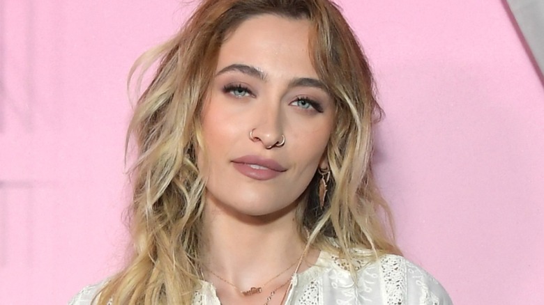 Paris Jackson on the red carpet posing in front of a pink background