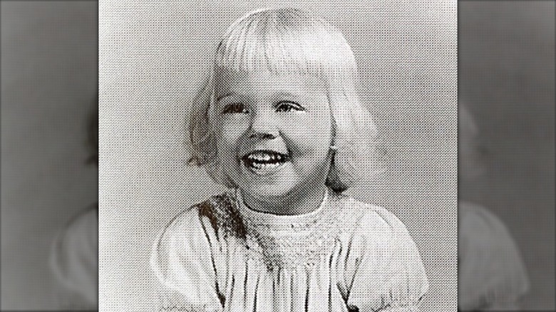 Black-and-white photo of Cybill Shepherd smiling as a young child