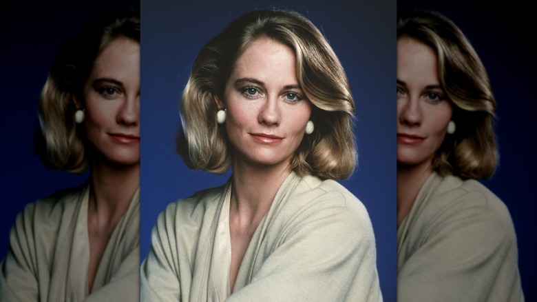 Cybill Shepherd posing for a portrait in 1985 in front of a blue background