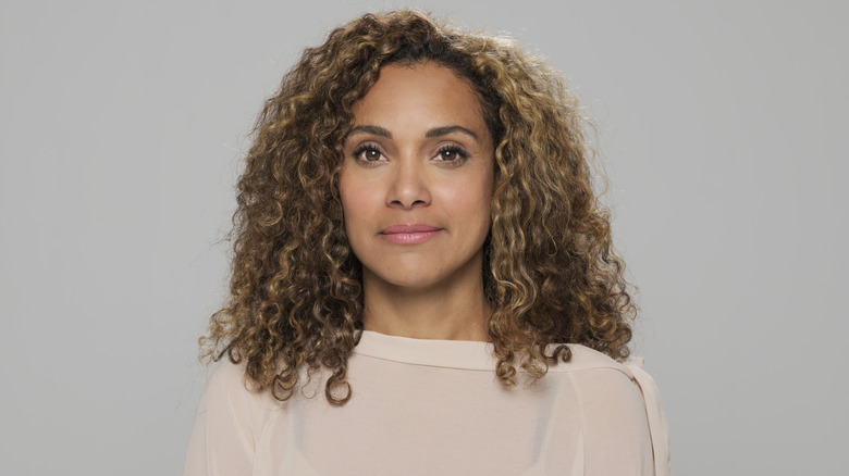Woman with light brown eyes and caramel blond hair