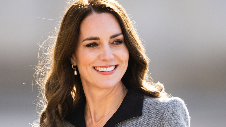 Kate Middleton smiling in a gray jacket