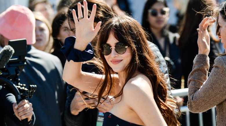 Dakota Johnson with a scrunchie on her wrist