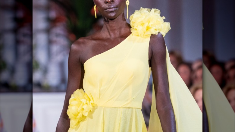 torso with yellow flowers on yellow dress
