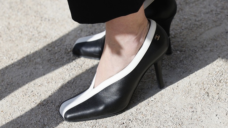 A woman wearing two-tone black-and-white shoes