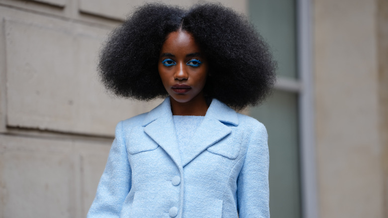 Model in blue outfit photographed in Paris in 2025
