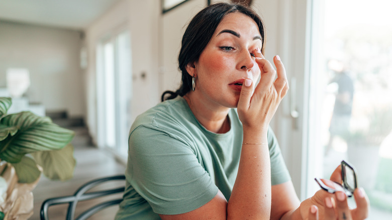 Woman applying makeup