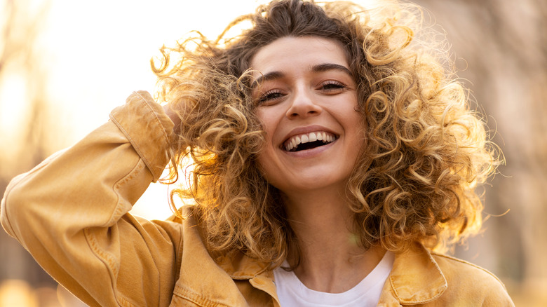 Woman with curly hair smiling