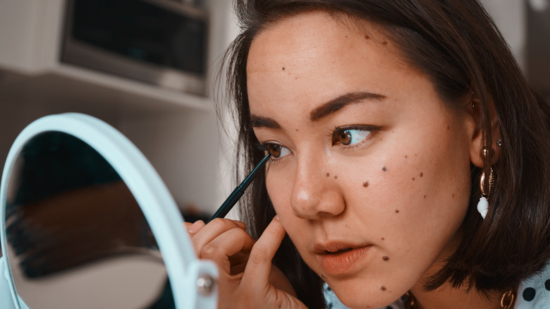 Woman with graphic liner dots 