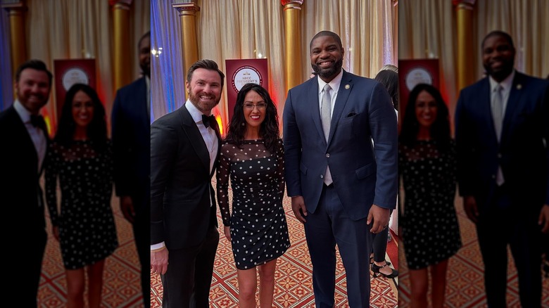 Lauren Boebert and Byron Donalds smiling with a fan at the NRCC President's Dinner in April 2025