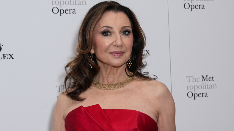 Donna Murphy on the red carpet in a red dress