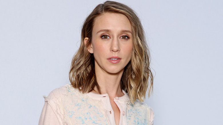 Taissa Farmiga with blonde hair against a white background
