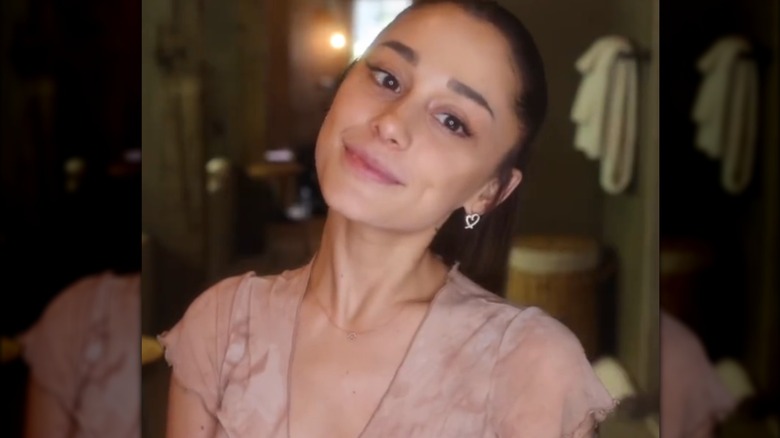 Ariana Grande smiling at the camera with no makeup on
