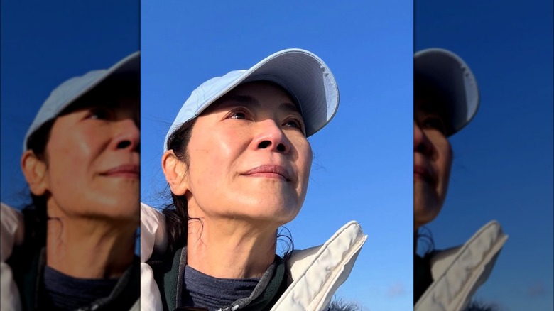 A selfie of Michelle Yeoh with clear blue sky behind