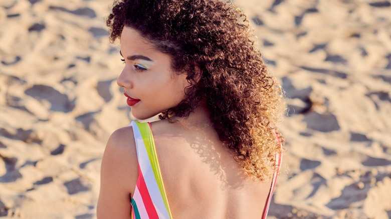 Woman in low-back swimsuit