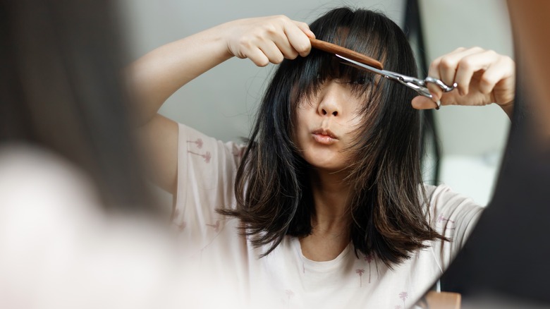 woman styling bangs